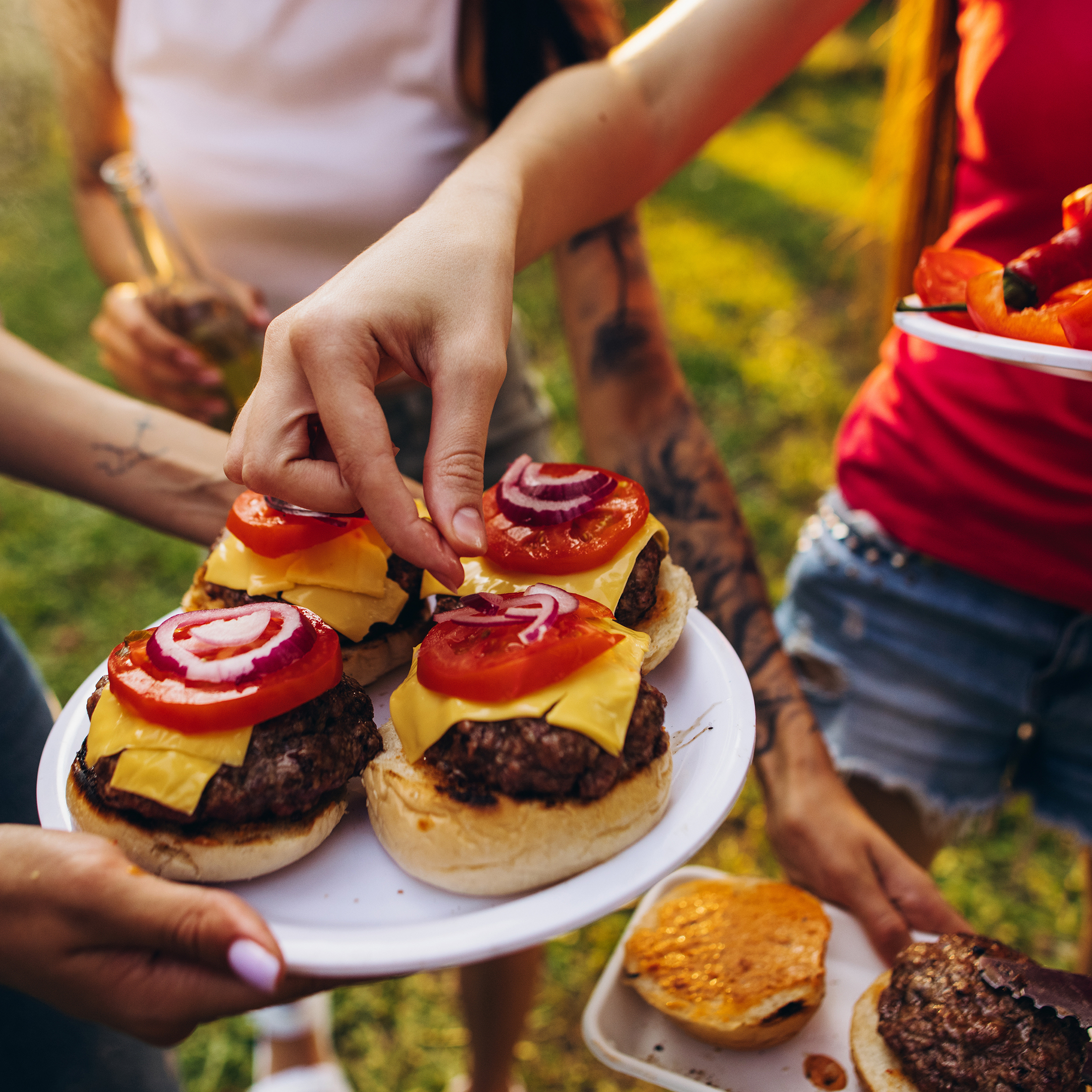 Cheeseburgers fresh off the grill at a backyard cookout